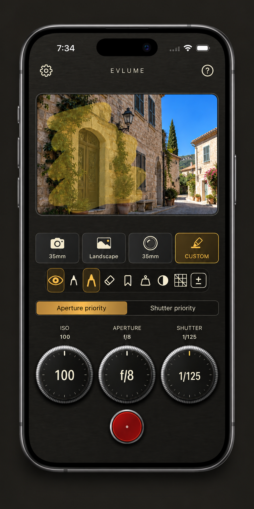 An iPhone displaying an illustrative Evlume Custom metering preview with the shaded facade of a building highlighted beneath a bright sky.